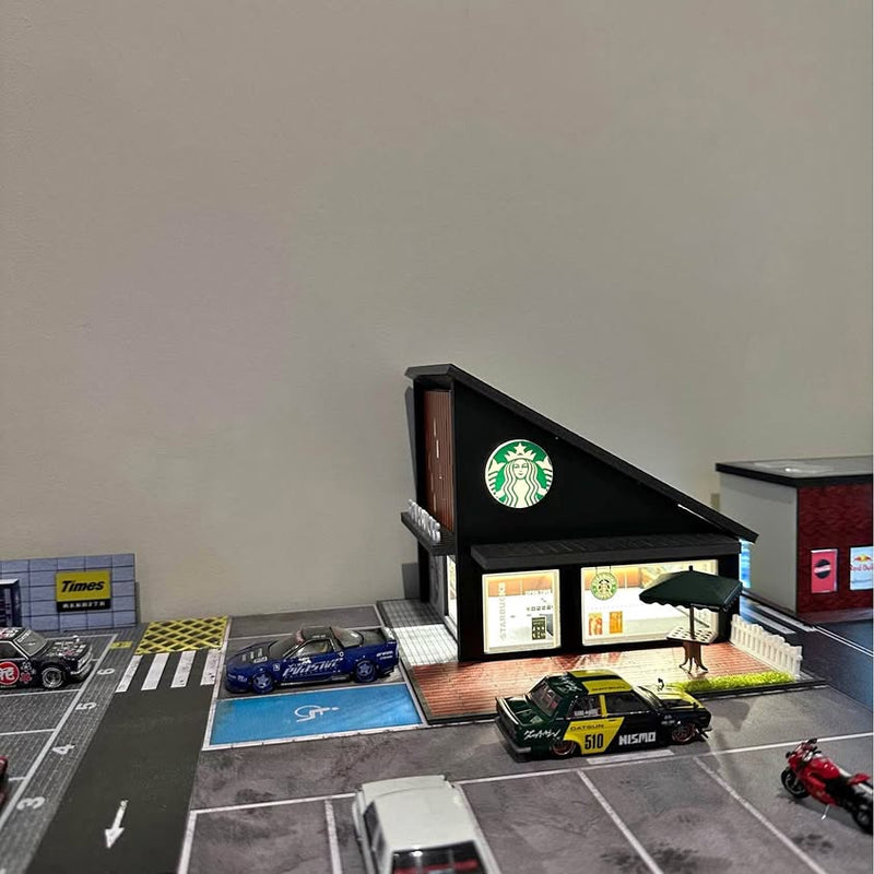 Starbucks light-up diorama with miniature storefront, brick base, and parked diecast cars
