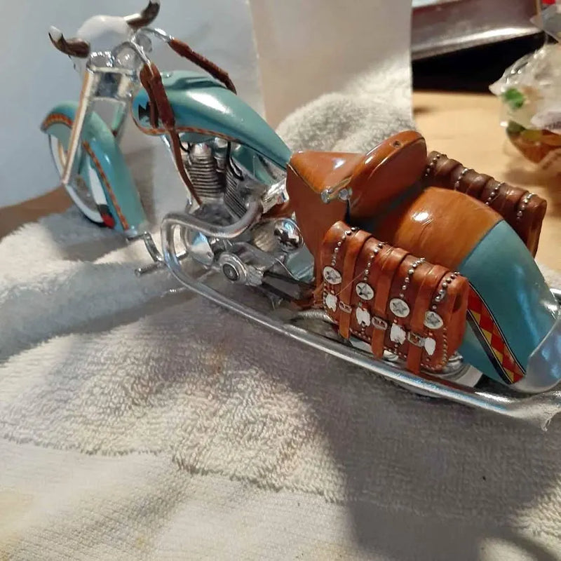 Teal diecast motorcycle model with chrome engine and brown seat