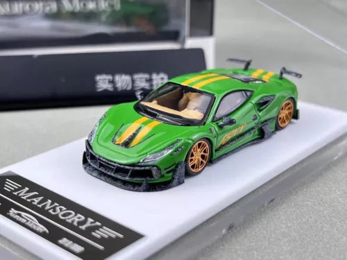 Green diecast sports model car with black front splitter, orange wheels, on display base
