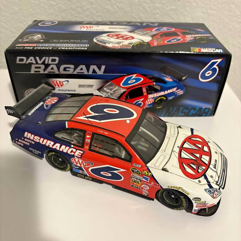 NASCAR diecast race car model with orange, blue, and white livery in display box