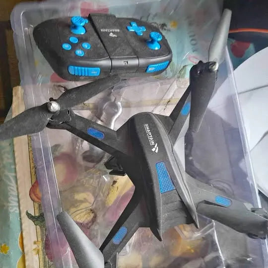 Black foldable quadcopter drone with blue accents and prop guards