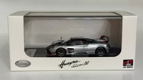 Silver die-cast roadster model in display case with clear window