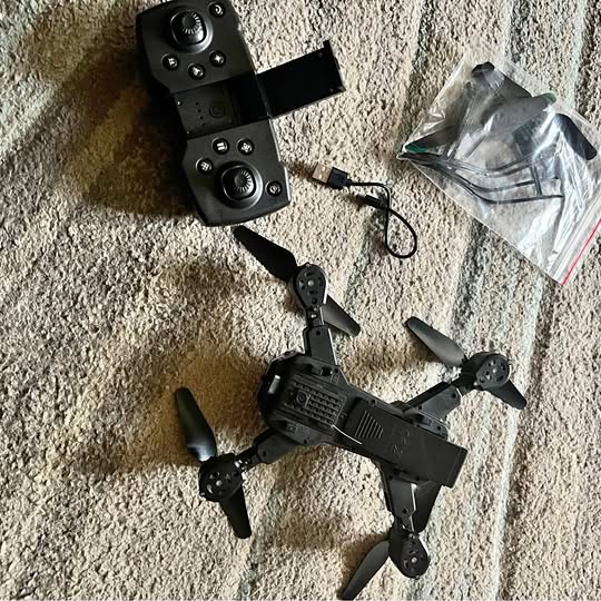 Drone Pro drone kit with remote controller, cables, and spare parts