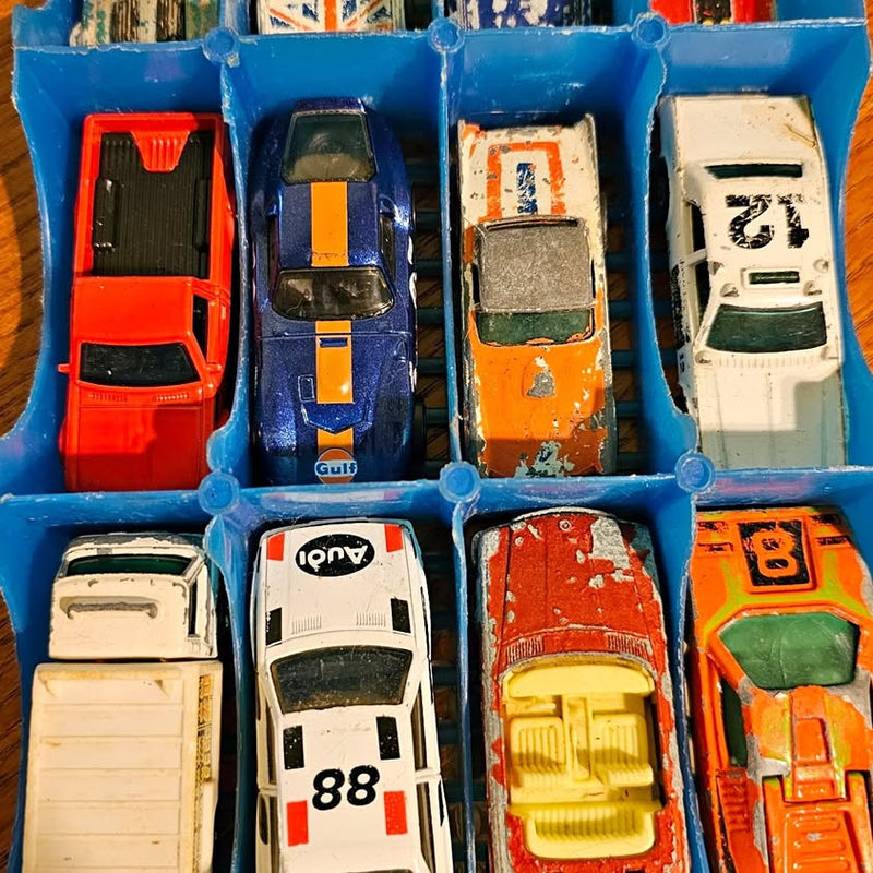 Vintage diecast cars in blue tray box, multiple vehicle styles and colors
