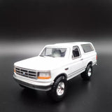 White 1993 Ford Bronco XLT diecast model SUV car, front 3/4 view