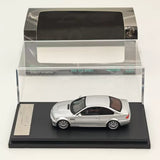 Silver diecast model car in display case, white roof, realistic wheels