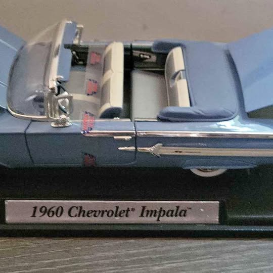 Light blue 1960 Chevy Impala convertible model car with open cabin and seats