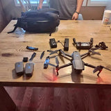 Drone with camera kit: folding quadcopter, controller, batteries, and charging cables