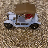 Vintage diecast model coupe car with light blue body, brown roof, black wheels