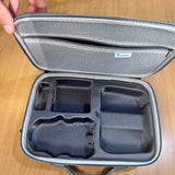 Drone carry case with foam inserts, open lid and molded compartments inside