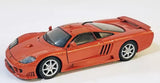 Orange 1:24 diecast sports car model with white racing stripe