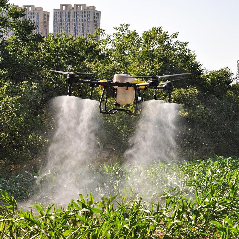 Agricultural UAV drone with pesticide sprayer, spraying a mist over crops