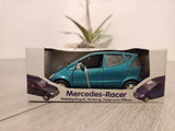 Teal diecast toy car in retail box, Mercedes-Racer branding and wheel details visible.