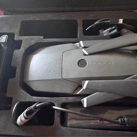 Gray DJI Mavic Pro drone in protective hard case, with controller cable and propellers