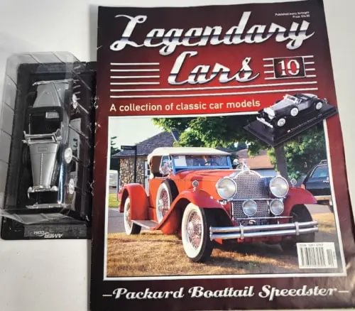 1:43 diecast car model in clear case, with magazine cover featuring a red car