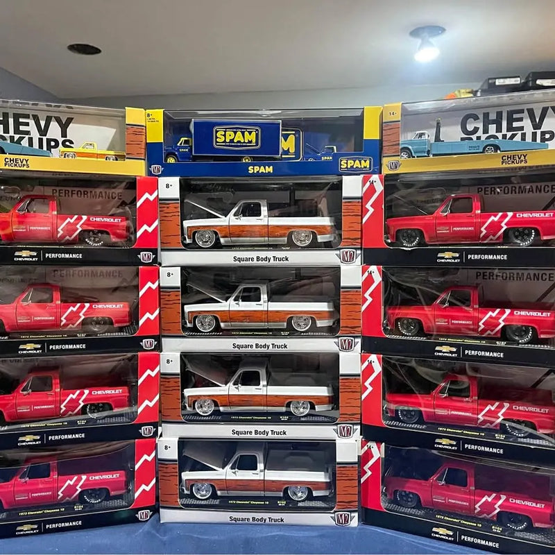Boxed diecast pickup truck models, red and white, Chevrolet Square Body style