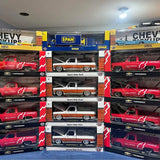 Boxed diecast pickup truck models, red and white, Chevrolet Square Body style