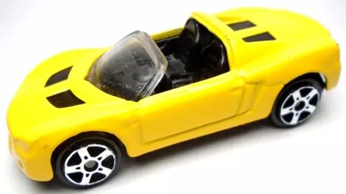Yellow convertible diecast car with black windshield and silver-spoke rims