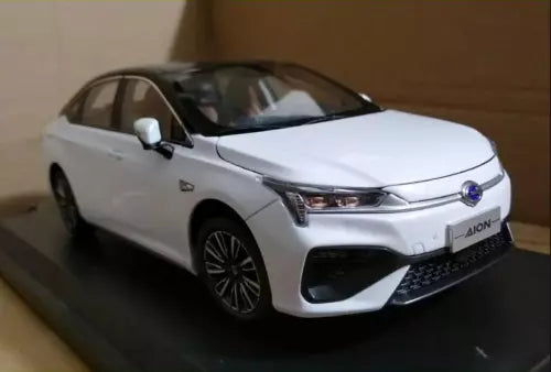 White diecast model car with open front view, black wheels and grille details
