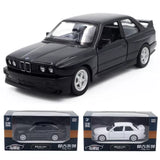 Black diecast coupe model car with alloy wheels, front 3/4 view.