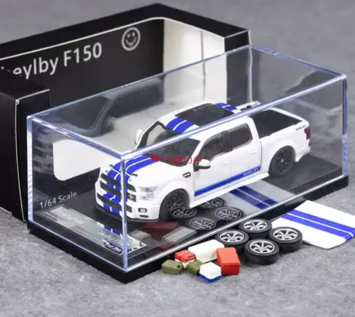 White 1/64 scale diecast pickup truck model with blue racing stripes in display box