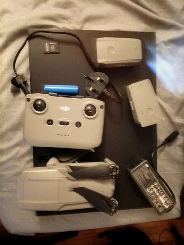 Gray DJI Mavic Air 2 quadcopter with controller, batteries, and chargers