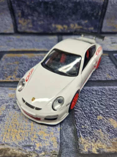 White diecast model car with red accents, front-left view