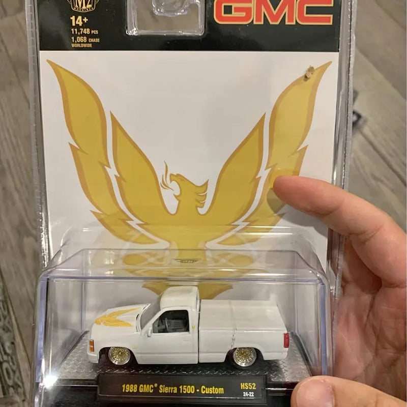 1:64 diecast pickup truck in box, white body with gold eagle graphic
