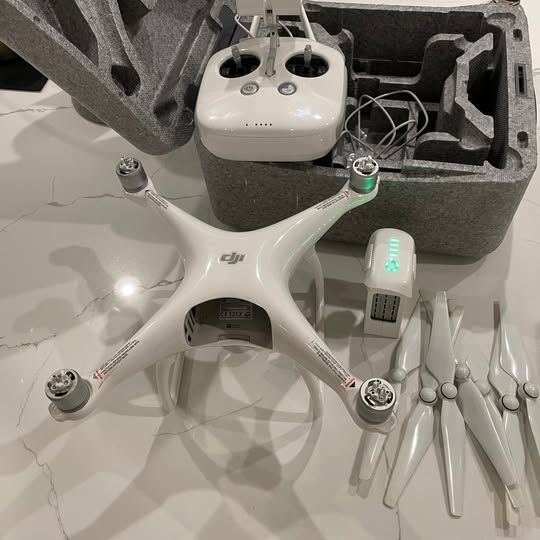 DJI Phantom 4 drone kit with white drone, case, battery, and accessories