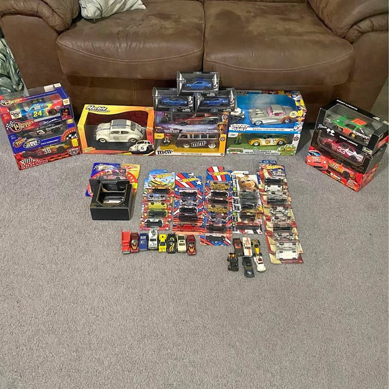 Diecast car and truck lot with multiple boxed models, assorted colors and designs