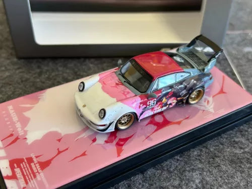 Diecast sports car toy, pink and white with red hood and #96 on display base