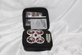 FPV quadcopter drone with red and white motors in black zip case