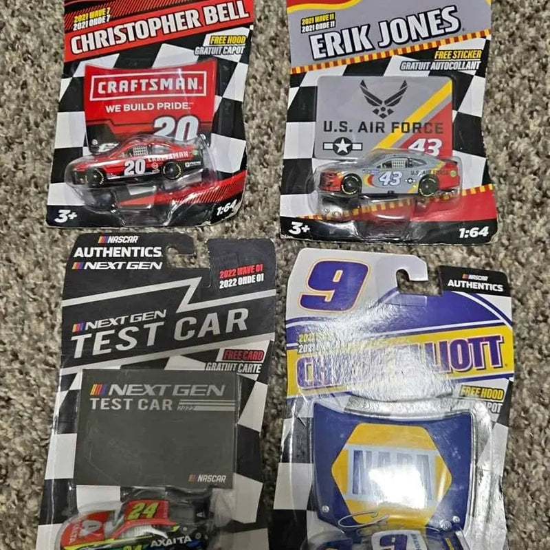 Packaged diecast race car models, including red Craftsman car and blue #9 car