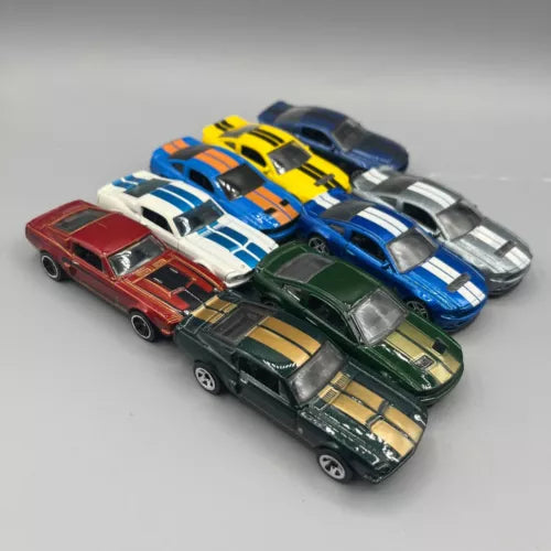 Racing diecast toy cars in red, green, blue, yellow, and silver with stripes