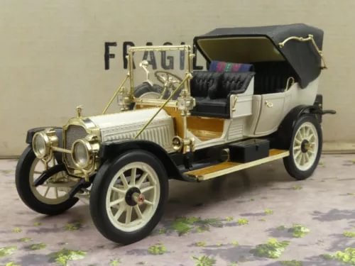 1:24 scale vintage diecast car with white body and black top, open hood