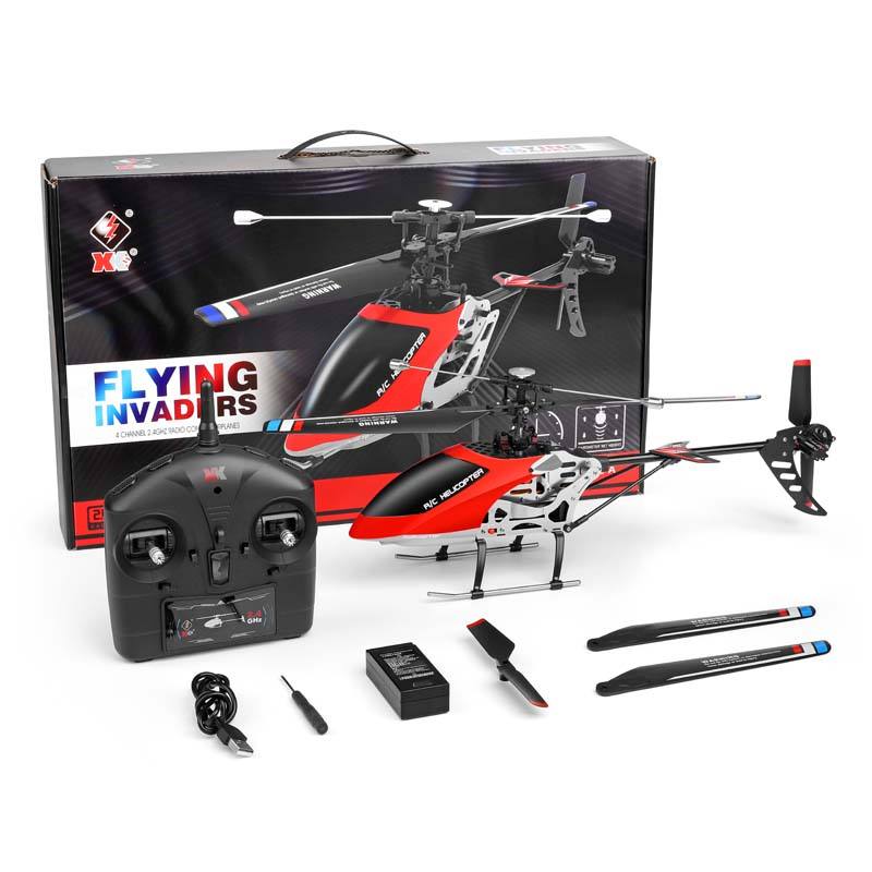 Red and black RC helicopter kit with controller, battery, charger, and blades