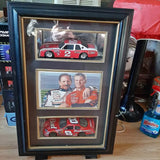 Black glass display case with diecast race car replicas and driver photos