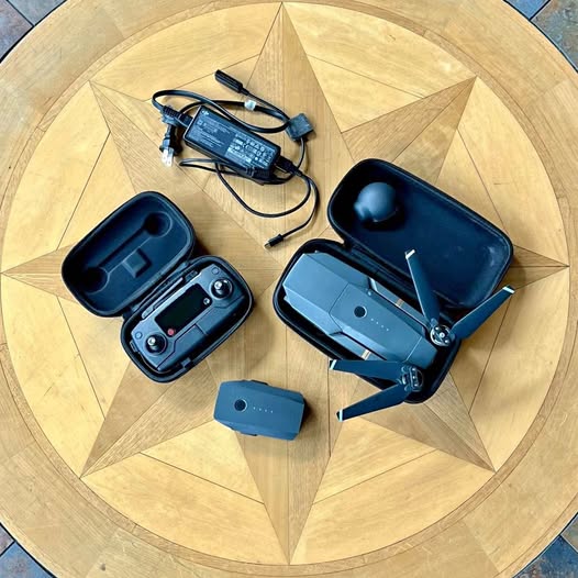 Foldable camera drone with remote controller, battery, and charging cable