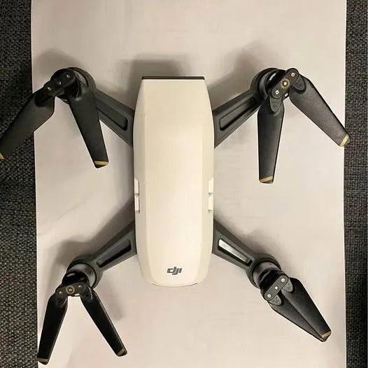 DJI Spark drone with four folded propeller arms and white body