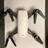DJI Spark drone with four folded propeller arms and white body