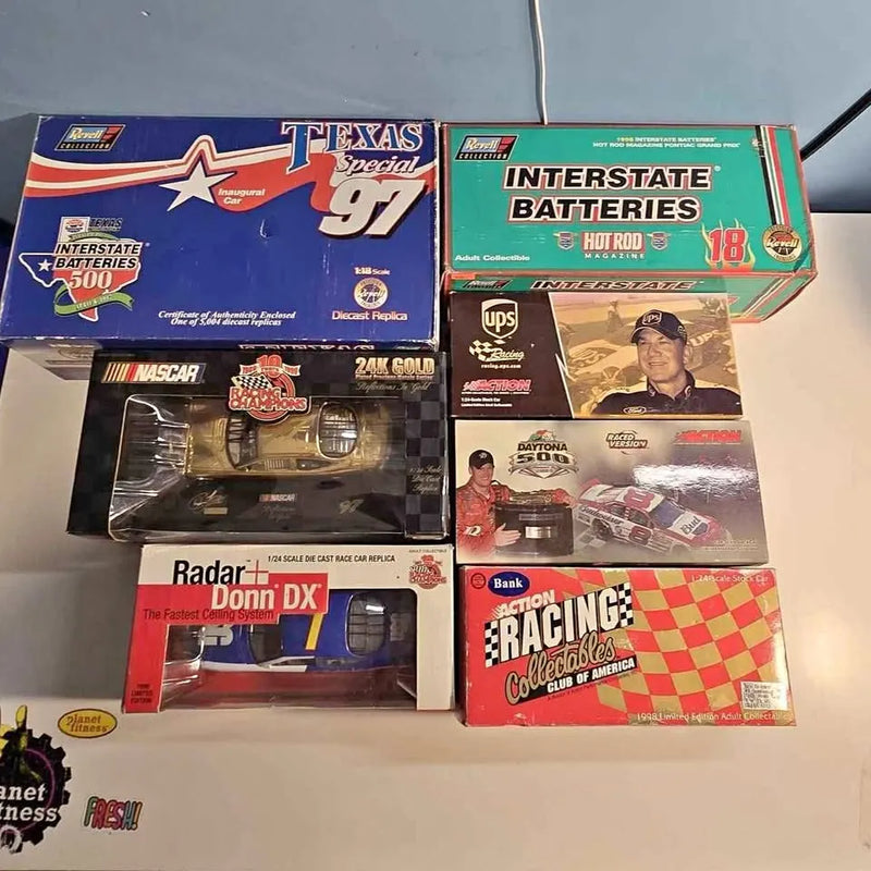 Boxed NASCAR diecast cars in multiple themed packages, with car display windows