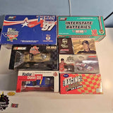 Boxed NASCAR diecast cars in multiple themed packages, with car display windows