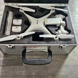 White quadcopter drone with propellers and controller accessories in a hard case