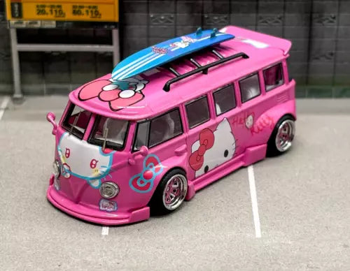 Pink VW T1 camper van diecast toy car with cartoon graphics and blue roof