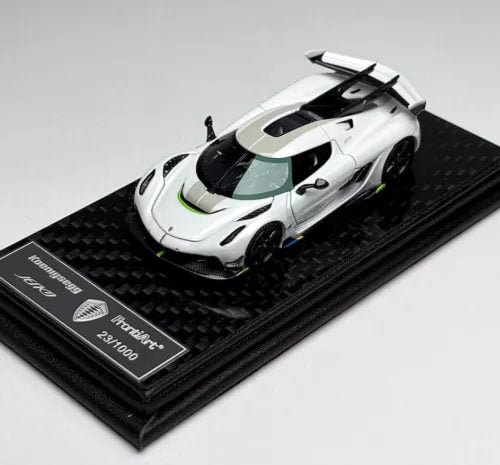 White 1:64 Jesko race car model diecast on black display base with carbon pattern