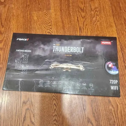 Drone retail box showing SYMA Thunderbolt specs: 720P WiFi, 3 batteries included