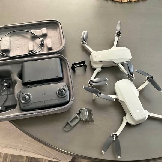 DJI Mavic Mini drone with remote controller, spare battery, and propeller guards