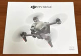 DJI FPV drone with four propellers, silver and dark gray body