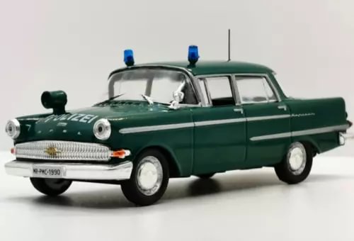 Vintage green police Opel Kapitan diecast car, 1:43 scale, side view with roof lights.