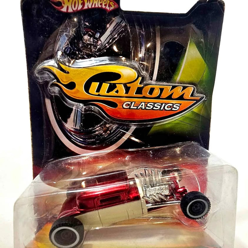Maroon and cream Hot Wheels diecast model car with chrome wheels in blister pack